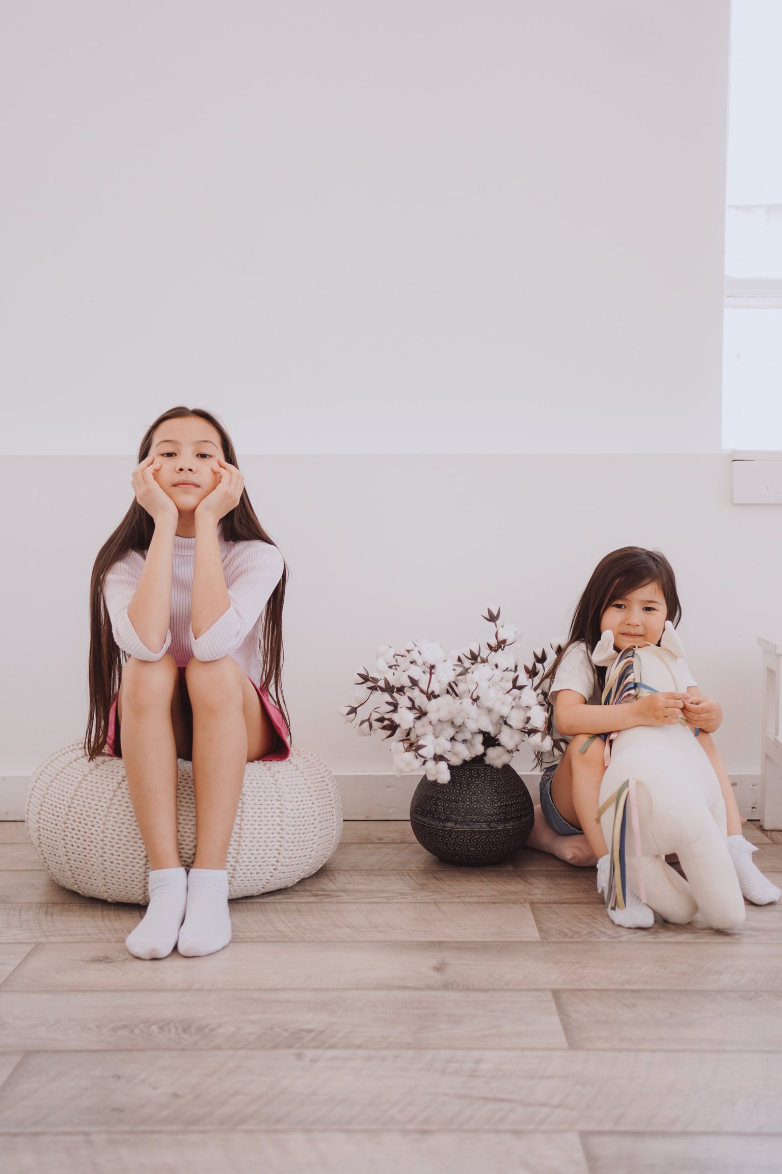 Sisters Sitting on the Floor in the Living Room